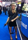 Photo of a girl wearing a military helmet at trade show in London