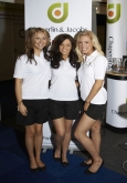 Photo of three girls at trade show in uniform